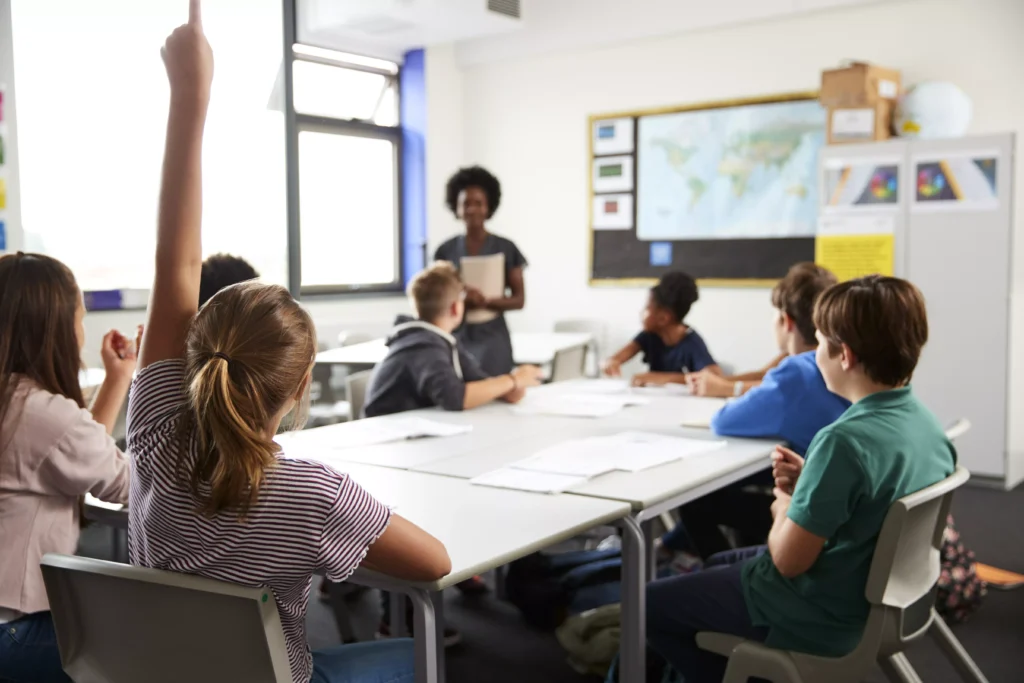 Teacher supporting pupils in a classroom