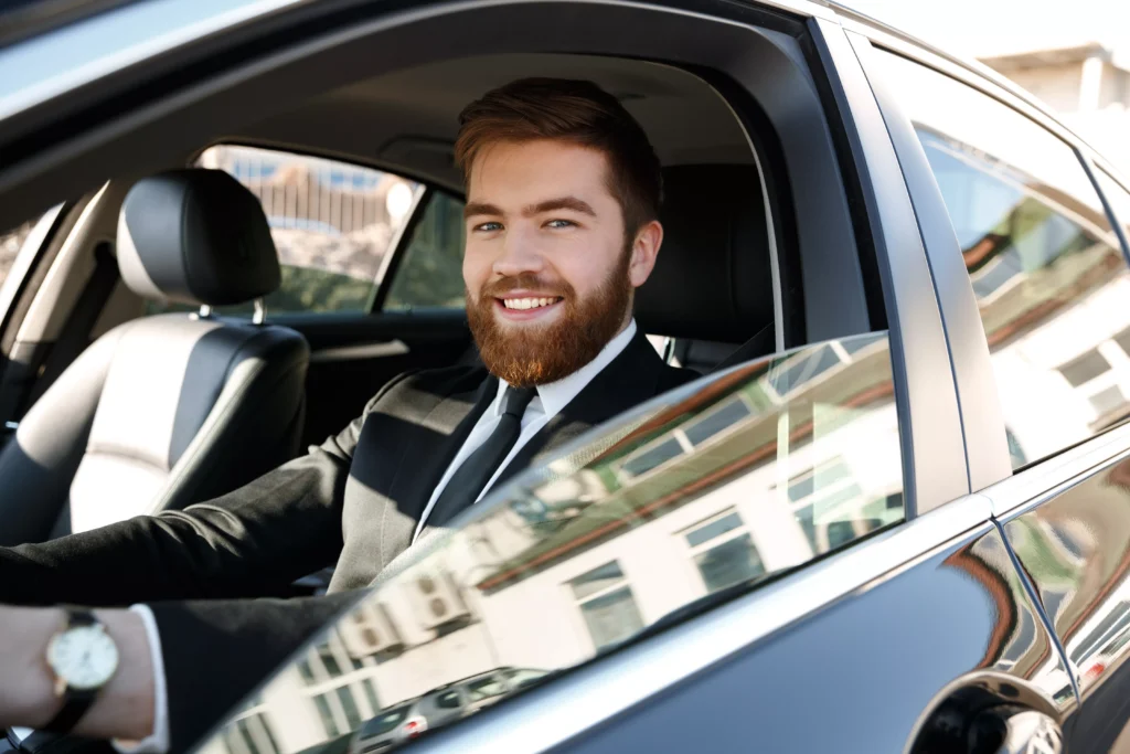 Taxi driver sitting in a private hire vehicle